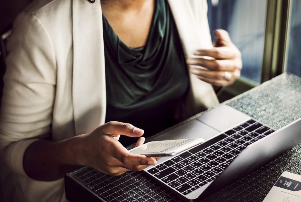 Woman using digital devices at a cafe